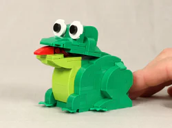 Little green frog with a tongue out.